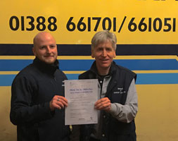 Cameron with Malcolm holding his HGV Pass certificate - well done!