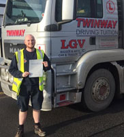 Cameron proudly displaying his HGV pass certificate.