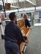 Staff placing Piano on Platform 2 at Durham City Station.